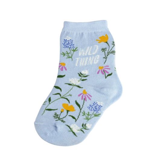 Child's sock, light blue, with flowers and the phrase 'Wild Thing' written on it.
