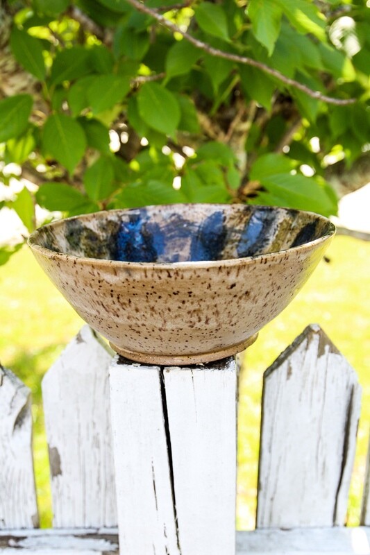 large tan and dark blue bowl with swirl in the in the bottom
