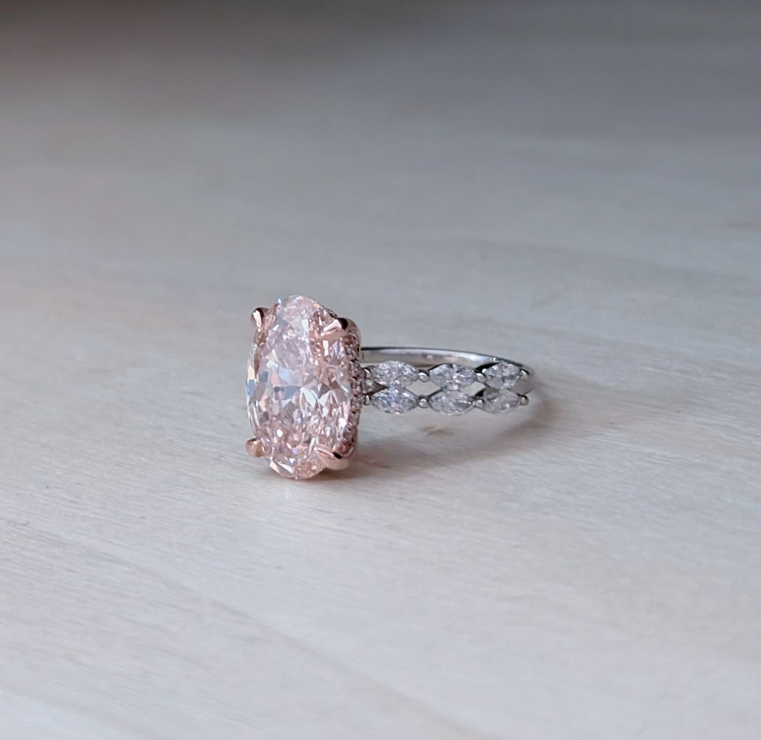 5.02 ct Fancy Intense Pink Oval in Hidden Halo Rose and White Marquise Accented Setting Size 7