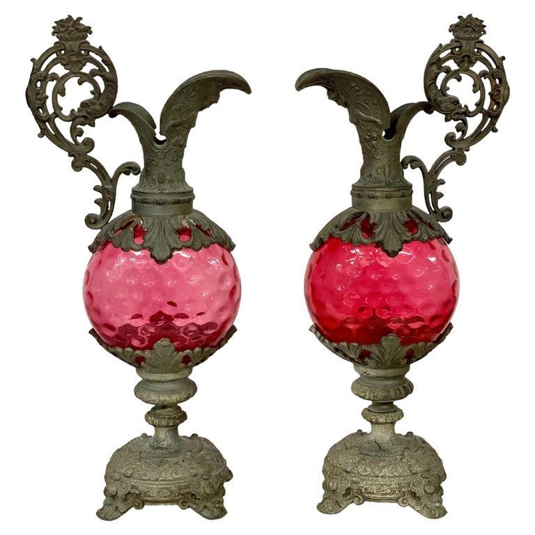 Pair of tall silver-plated metal ewers with pink glass, dating from the 19th century