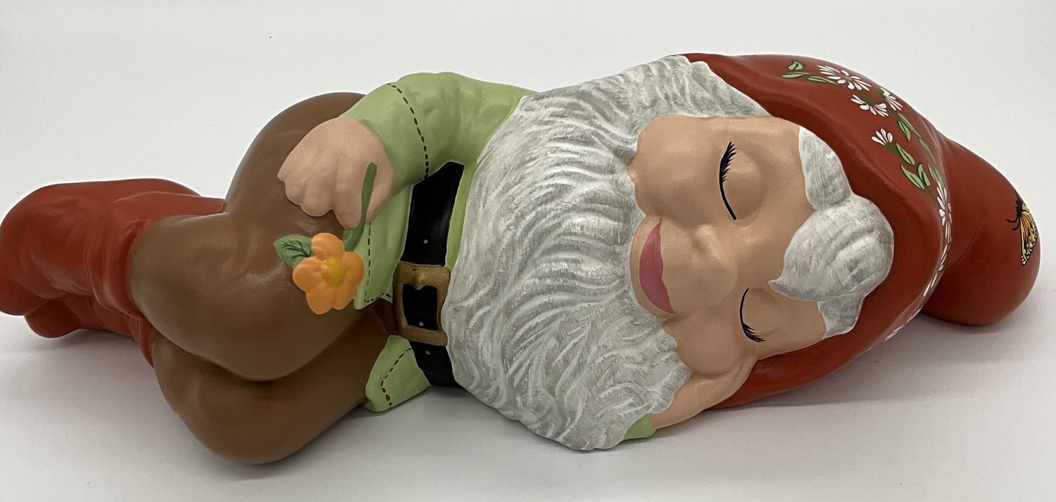 Gnome laying on side with handpainted flowers