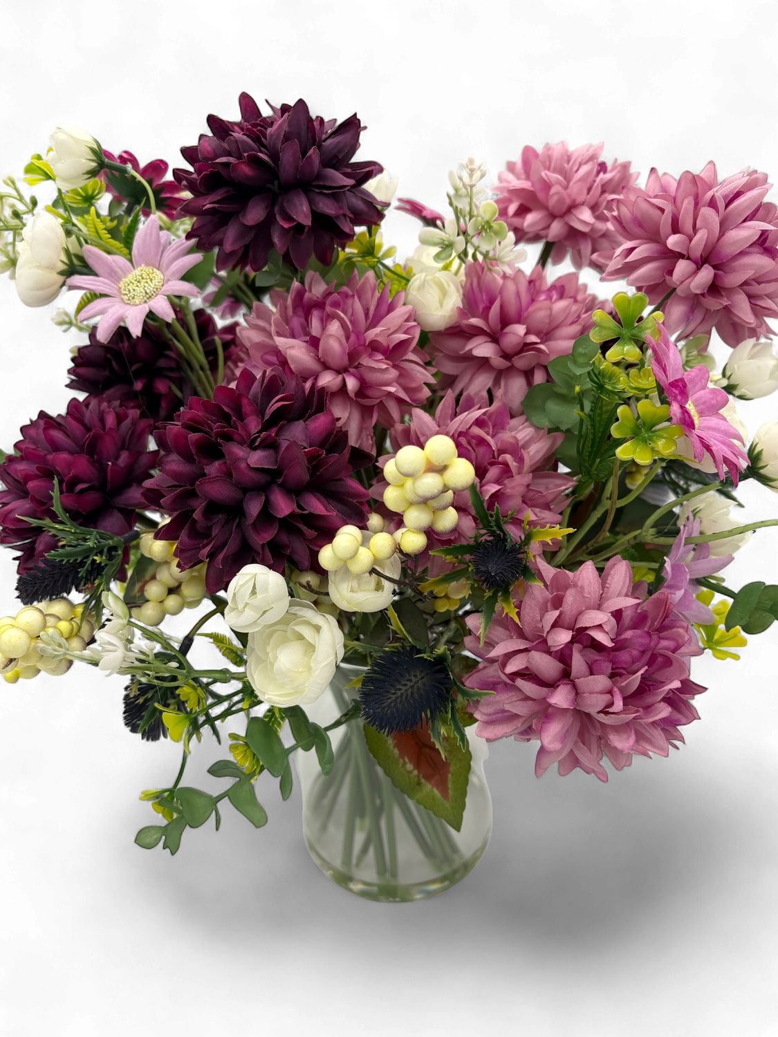 Floral arrangement in pink, plum &amp; cream in glass vase