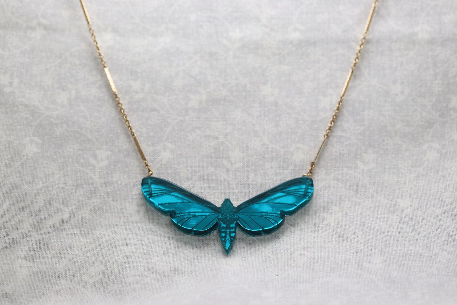 Dynasty by Kamilla Thorsen jade green resin moth necklace