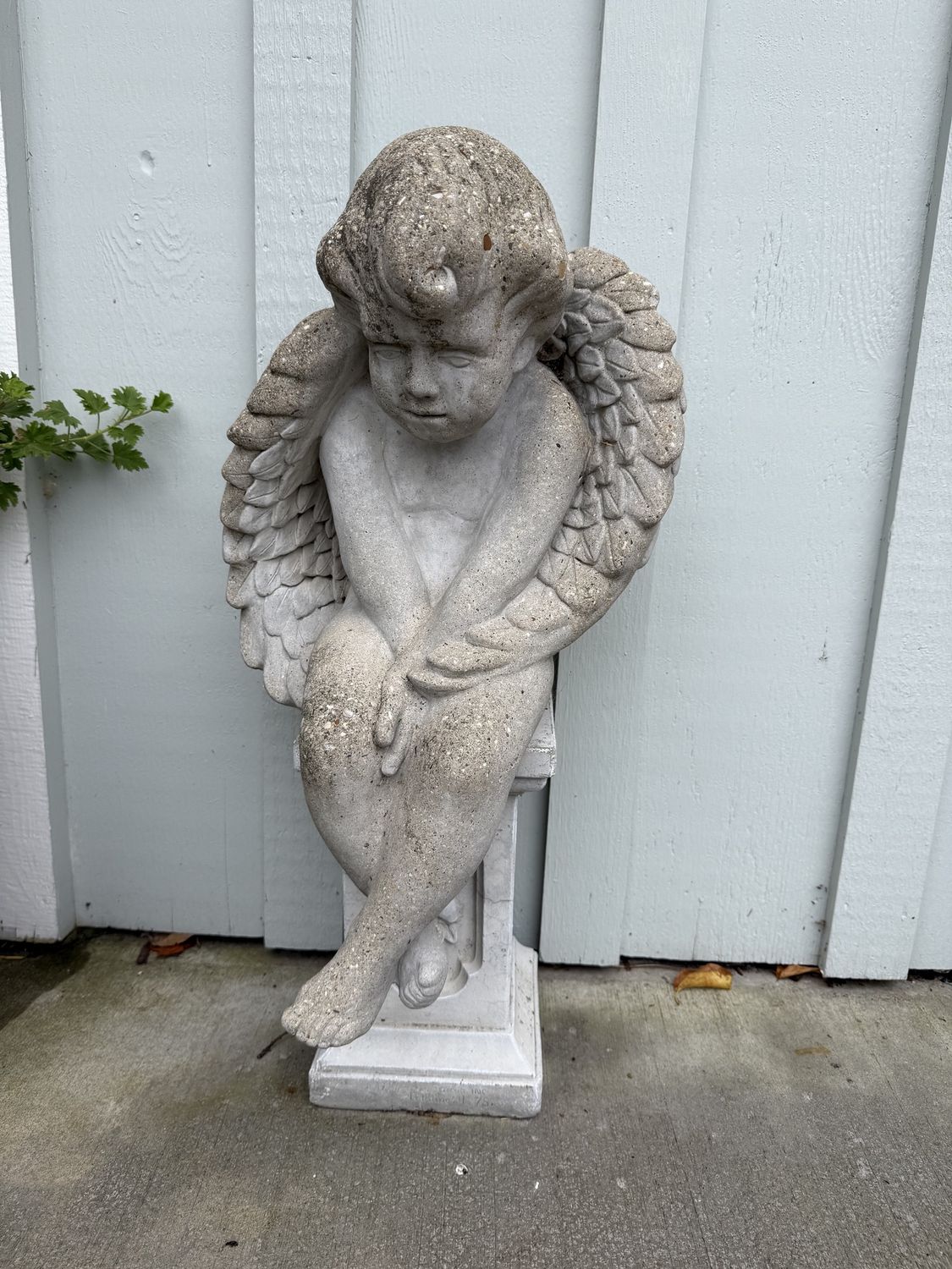 Cement Sullen Angel Seated on Plinth