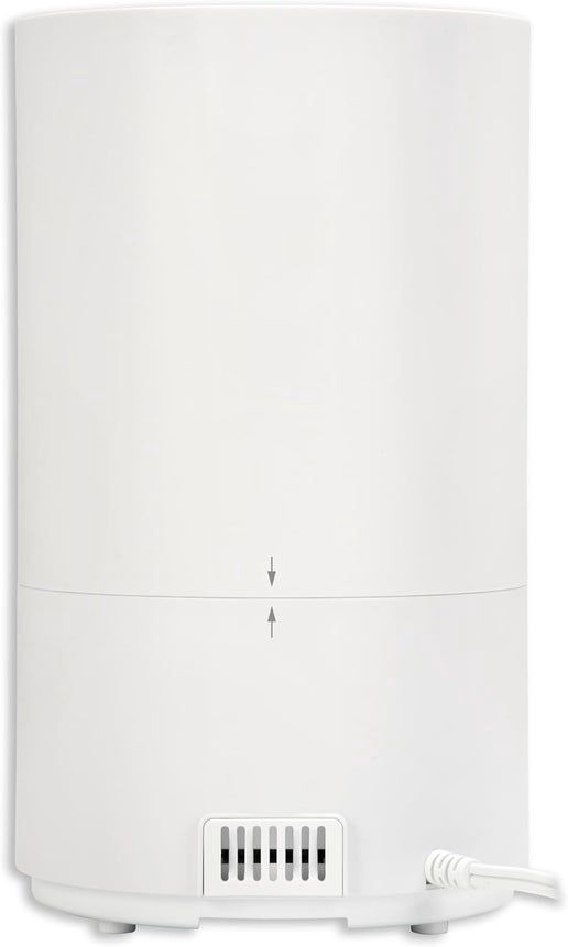 Modern cool mist ultrasonic humidifier with sleek white design, water tank, and aromatherapy diffuser feature for home use.