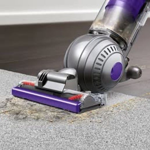 Dyson Ball Animal 2 upright vacuum cleaner in purple and silver with large ball for easy steering