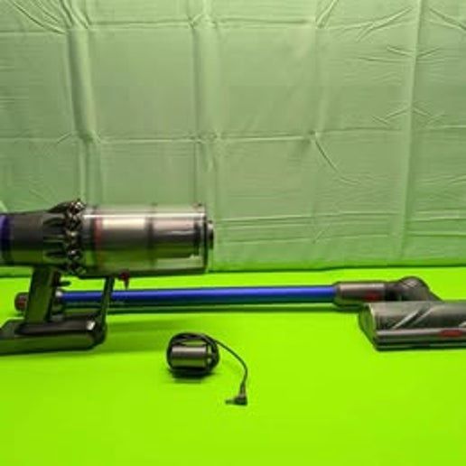 Full set of Dyson V11 Torque Drive vacuum components, including main unit, attachments, charger, and wand, arranged together