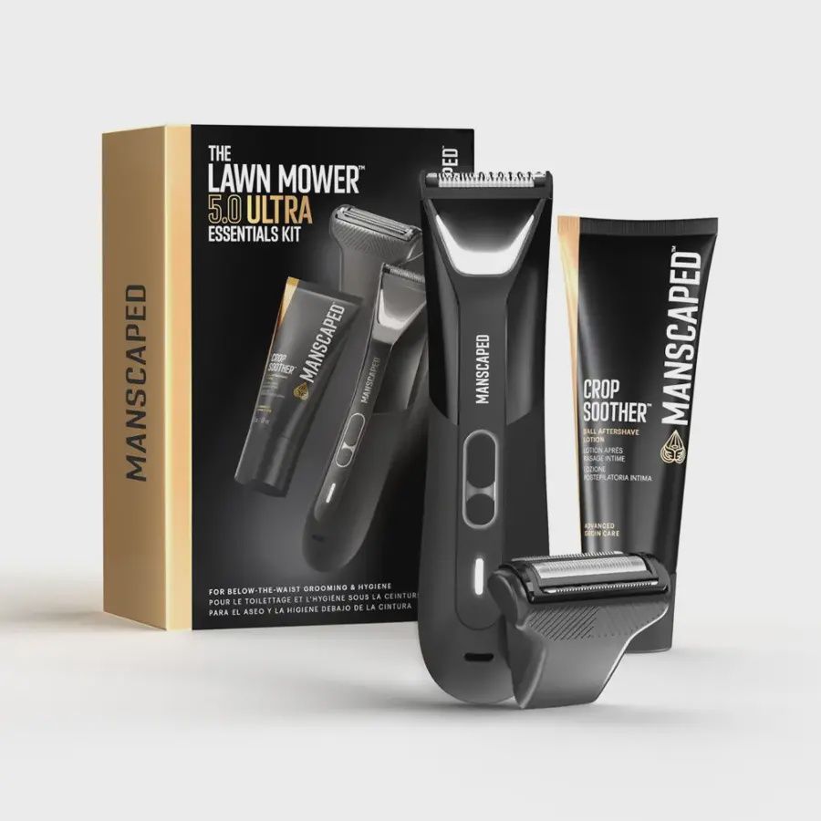 Manscaped Lawn Mower 5.0 electric trimmer displayed with all attachments and accessories next to its packaging box.