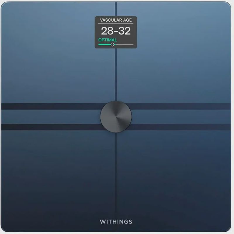 Withings Body Comp smart scale front view showing a sleek, tempered‑glass surface with four measurement sensors.