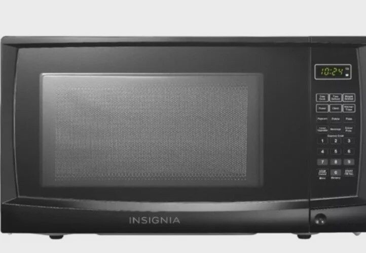 Insignia 0.7 Cu Ft Compact Countertop Microwave shown from front angle with door closed and control panel visible.