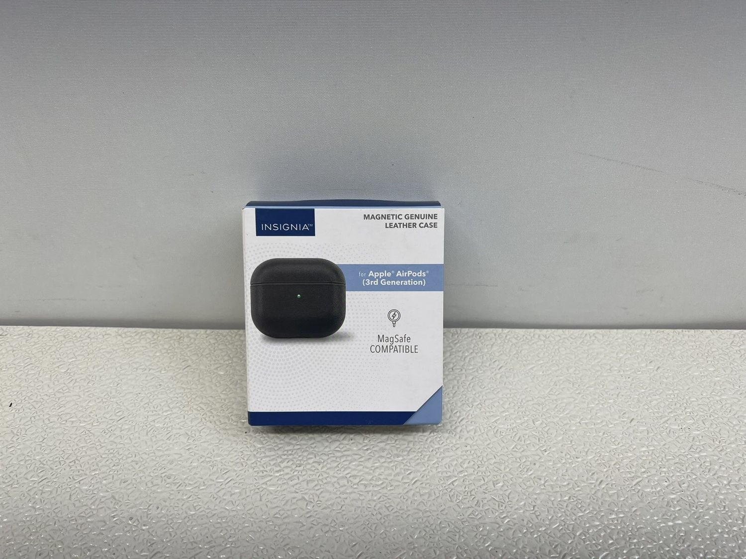 Retail packaging box for Insignia magnetic leather case for Apple AirPods, showcasing product image