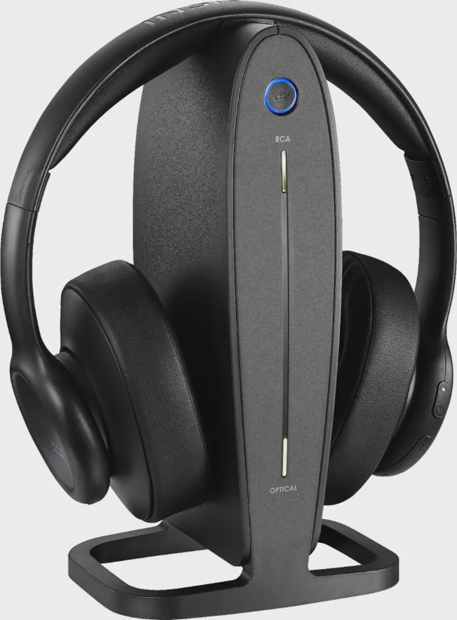 Insignia RF Wireless Over-the-Ear Headphones placed on charging docking station with base unit.