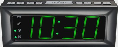 Close-up of Best Buy essentials™ BE-CLOPP3 Digital AM/FM Dual Alarm Clock showing green LED display and control buttons