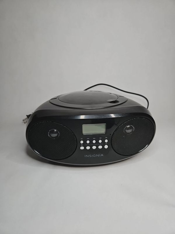 Front view of the Insignia CD Boombox AM/FM Radio showing control panel, CD compartment, and speakers.