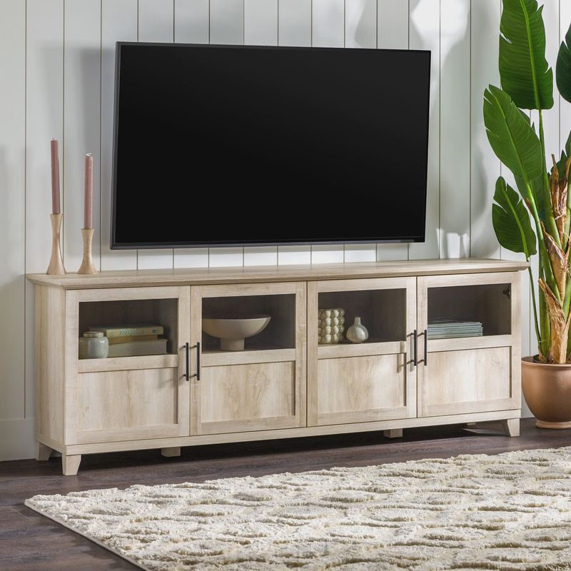 Walker Edison Farmhouse TV Stand Cabinet in white oak with a large flat-screen TV on top, styled in a cozy living room.