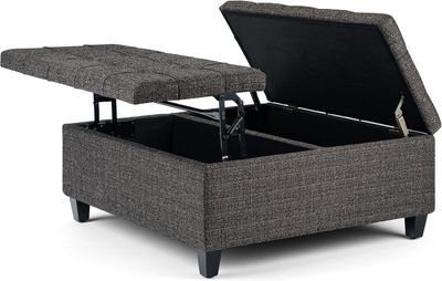 Ottoman with the top lifted to reveal spacious interior storage for blankets, pillows, or accessories.