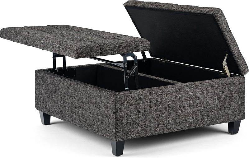 Ottoman with the top lifted to reveal spacious interior storage for blankets, pillows, or accessories.