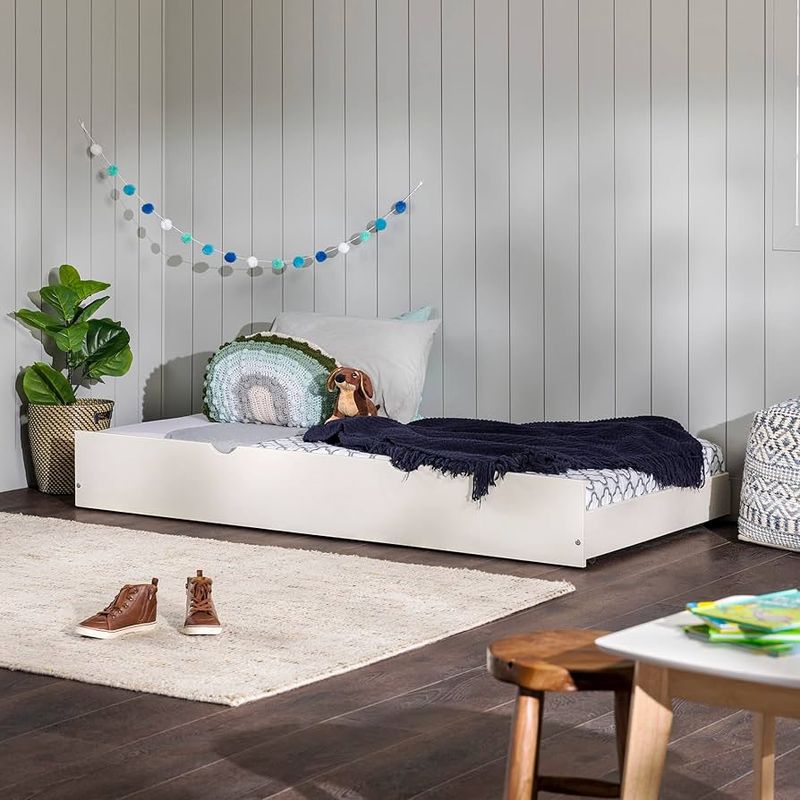 Walker Edison Solid Wood Twin Trundle Bed in white, shown in a bright room with pillows and bedding.