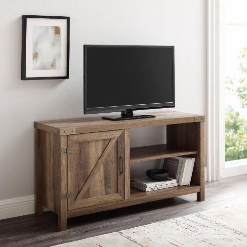 Walker Edison 44” Rustic Farmhouse TV Stand in rustic oak finish with a flat-screen TV on top.