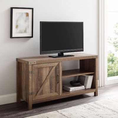 Walker Edison 44” Rustic Farmhouse TV Stand in rustic oak finish with a flat-screen TV on top.