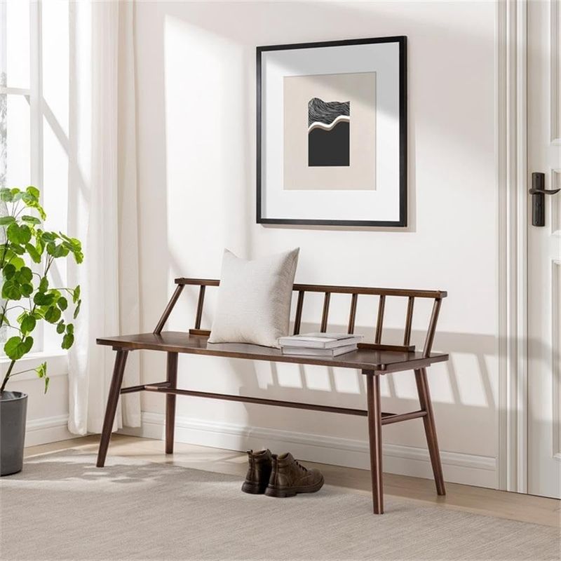 Walker Edison Lennon 48&quot; Spindle-Back Bench in walnut placed in a styled room with a decorative pillow on the seat.