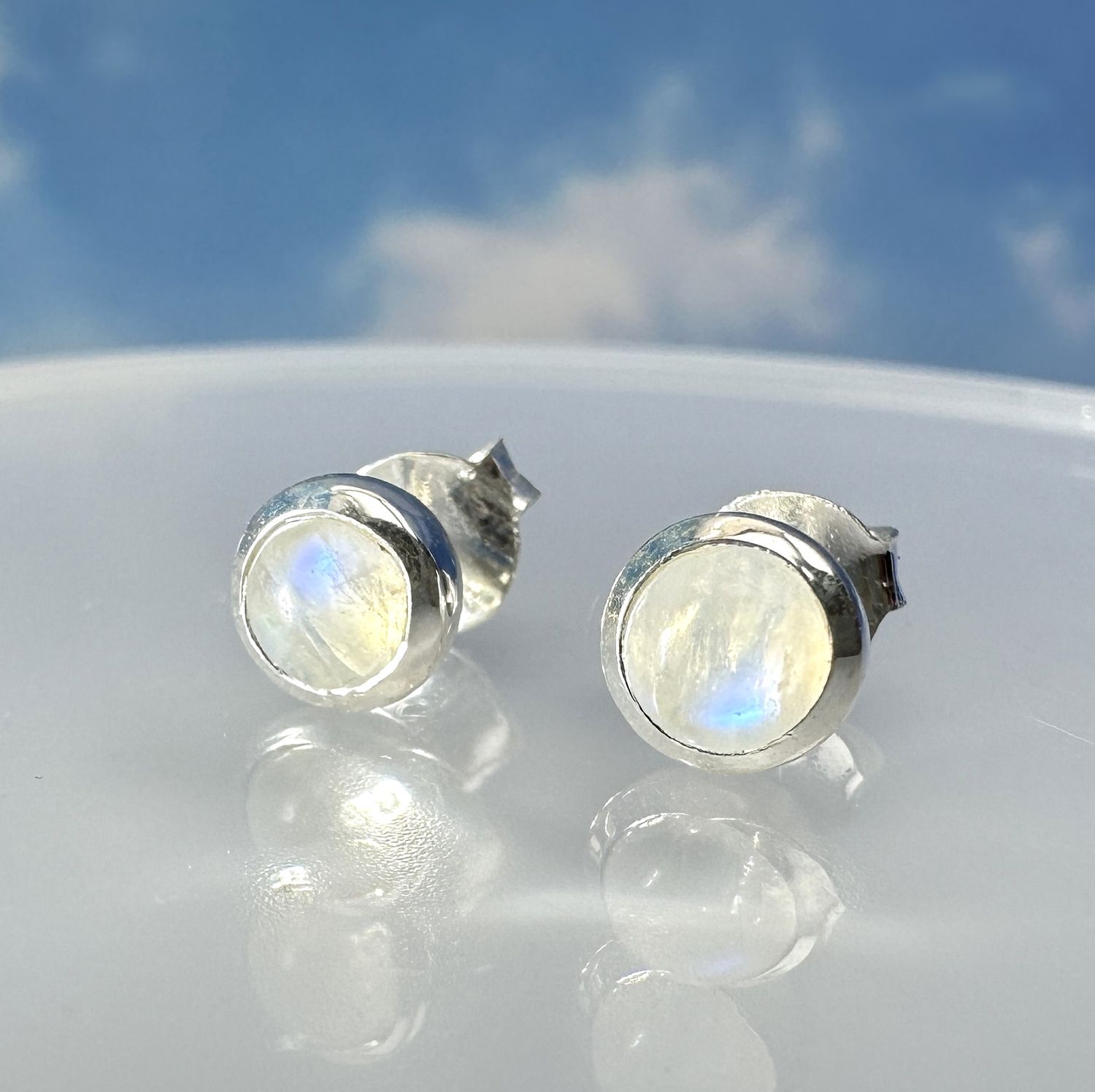 
Beautiful moonstone earrings/studs. The perfect cabochon cut refracts the light and enhances the mysterious blue shimmer of 