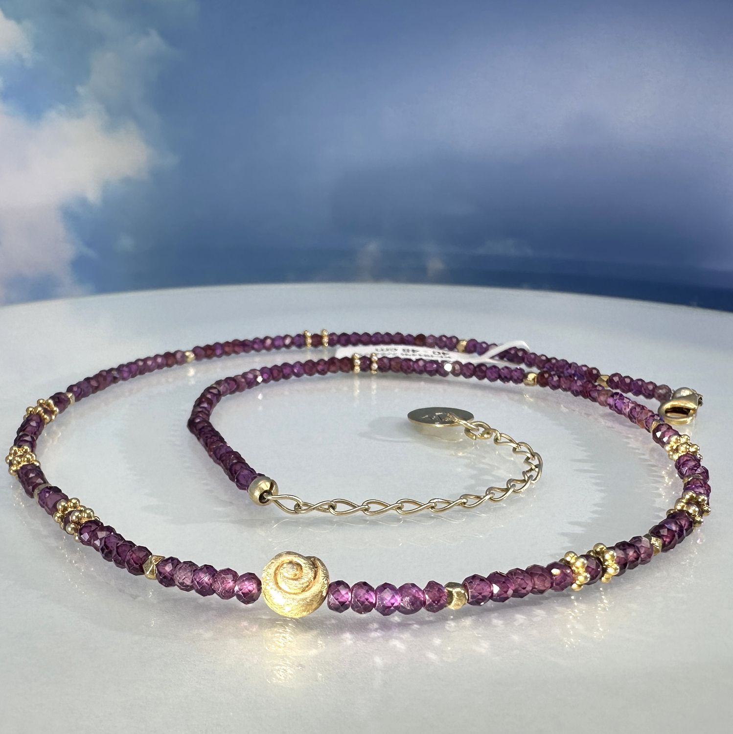 Elegant necklace made of genuine, faceted rhodolithe combined with gold plated 925 sterling silver.