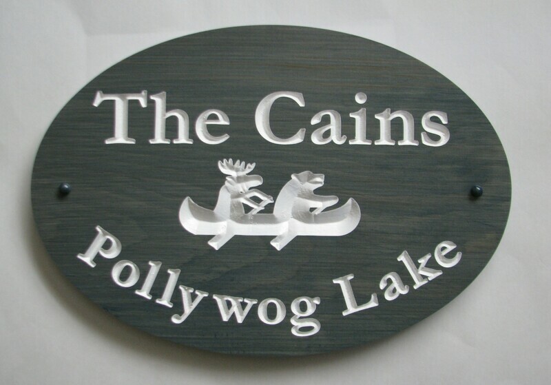 Stained Wood Oval Welcome Sign with Carved Bear Moose Canoe Graphic