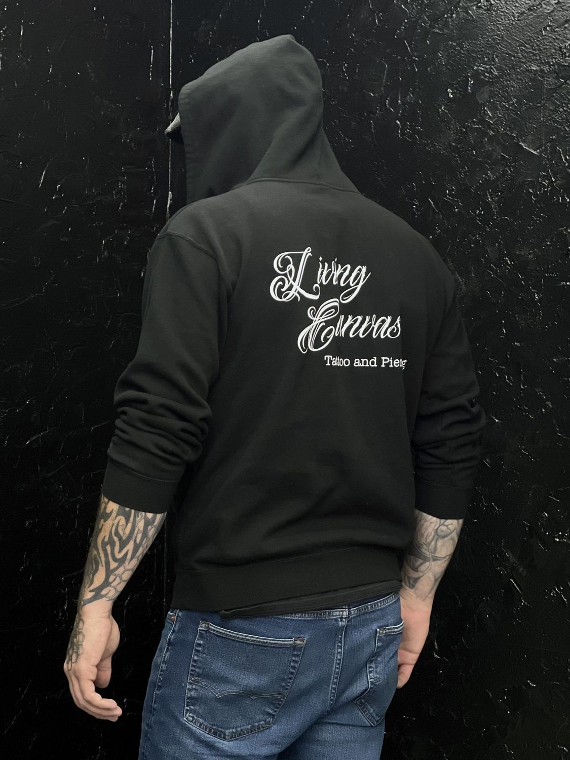 Black zip up hoodie, male and female,  Living Canvas Tattoo and Piercing Logo. Cotton and Polyester blend. Sizes S - 2XL