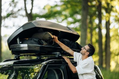 Roof boxes and hitch carriers