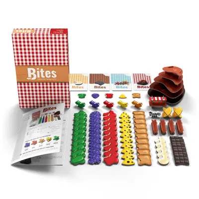 Bites board game components laid out, including box, rulebook, colorful food tokens, and modular pieces for 2-5 players aged 10+.