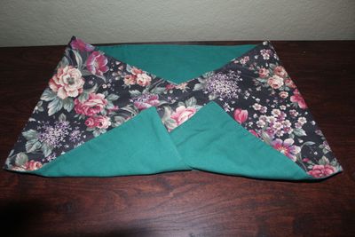 Reversible farmhouse table runner featuring vintage floral pattern and solid green side