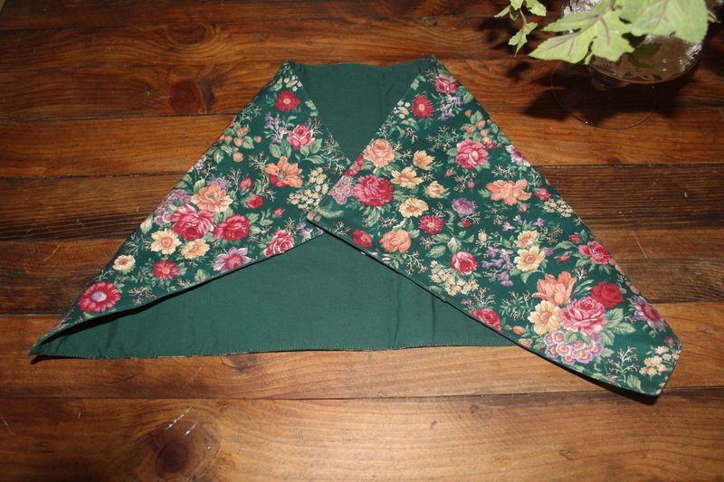 Handmade reversible green floral table runner on wooden table