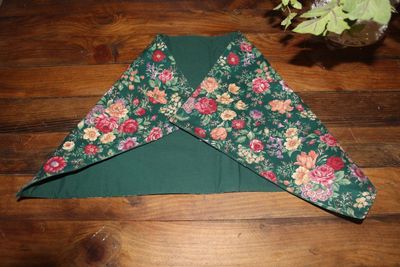 Handmade reversible green floral table runner on wooden table