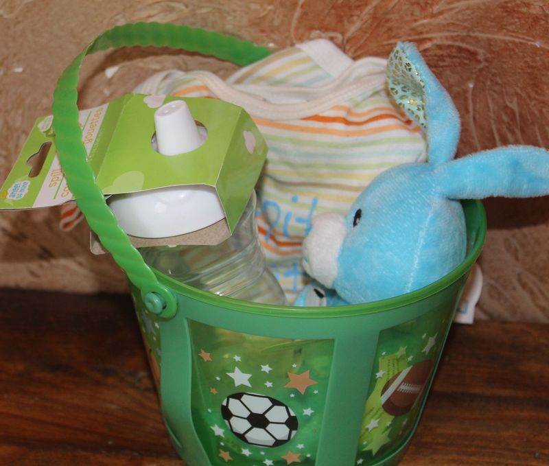Easter baby gift set with striped Hippity Hoppity bodysuit, blue bunny toy, and spill proof cup