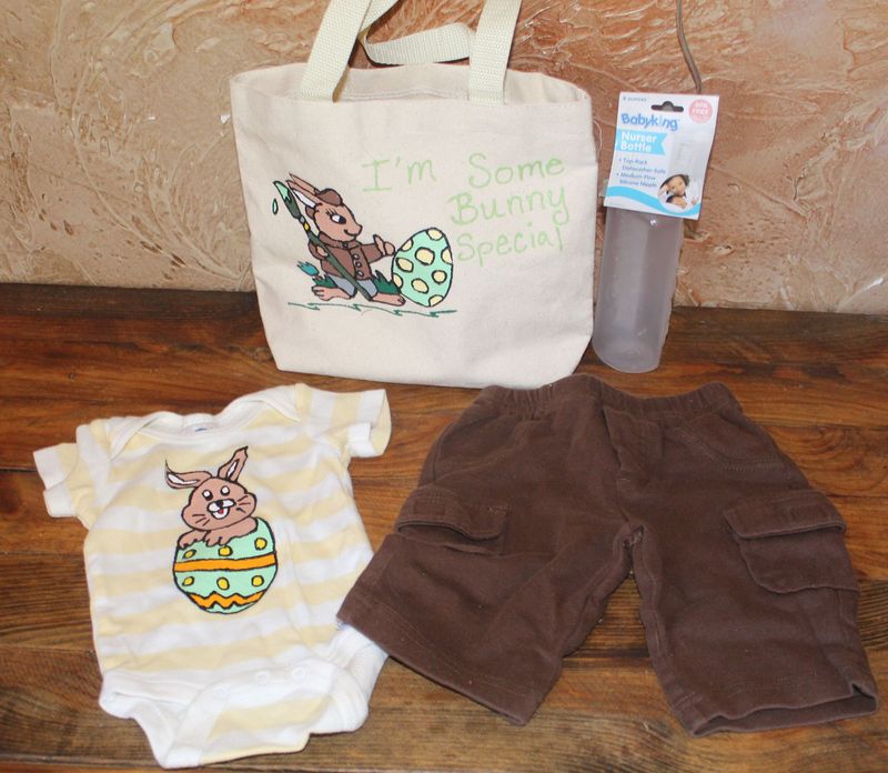Hand-painted Easter bunny baby gift set with onesie, brown shorts, bottle, and canvas tote bag.