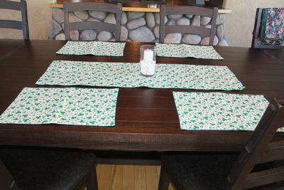 Handmade shamrock placemats set of 4 with matching shamrock table runner for St. Patrick’s Day dining table decor.