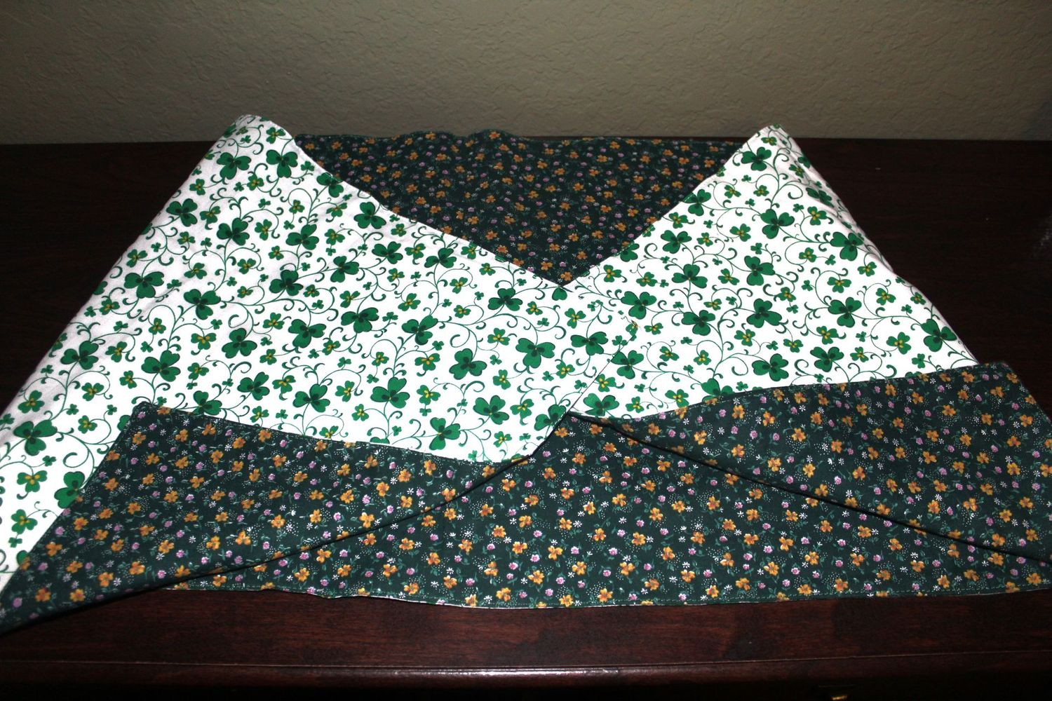 Handmade reversible shamrock and spring table runner for St. Patrick’s Day and seasonal dining table decor.