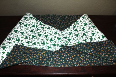 Handmade reversible shamrock and spring table runner for St. Patrick’s Day and seasonal dining table decor.