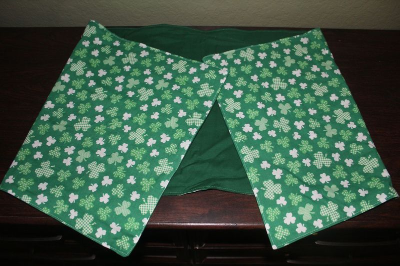 Handmade reversible shamrock table runner in festive green tones, featuring shamrock patterns with solid green. 