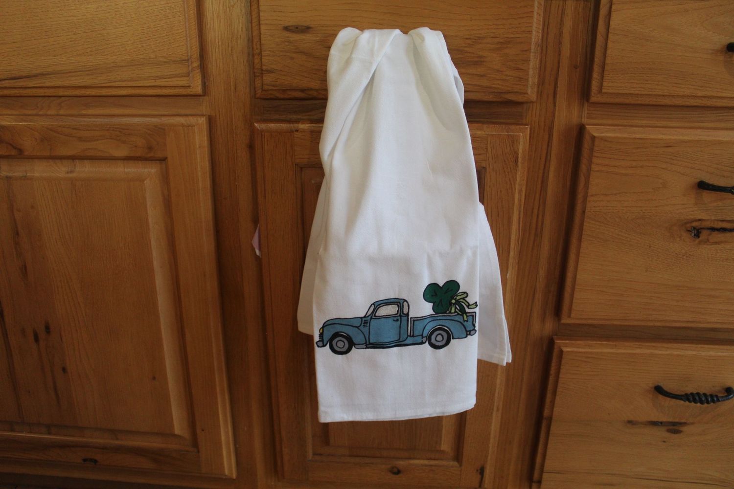 Handmade Irish-themed flour sack towel with vintage truck and shamrocks for St. Patrick’s kitchen decor.