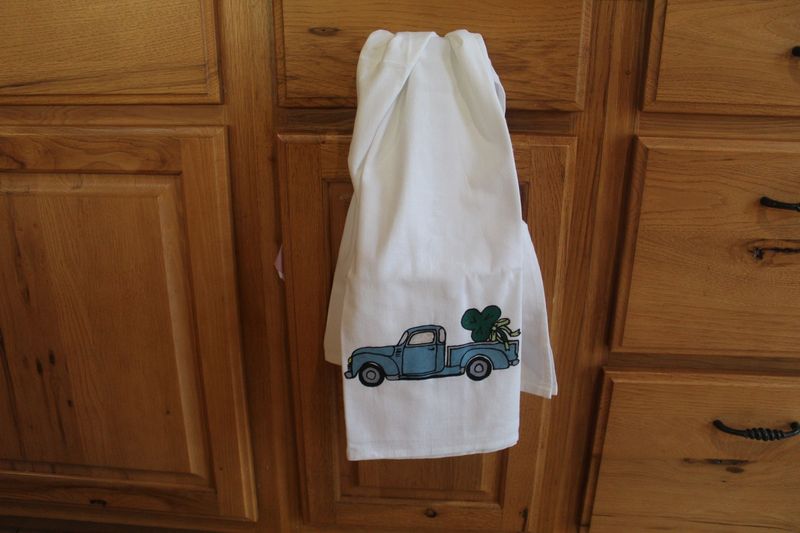 Handmade Irish-themed flour sack towel with vintage truck and shamrocks for St. Patrick’s kitchen decor.