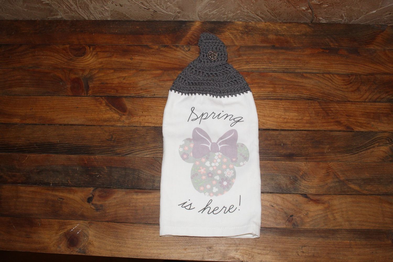 Handmade spring dish towel with crochet topper and “Spring Is Here” seasonal design.