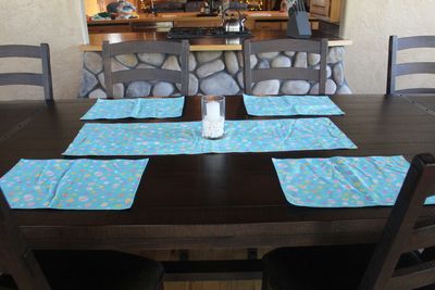 Handmade Easter table decor featuring egg placemats and coordinating table runner.