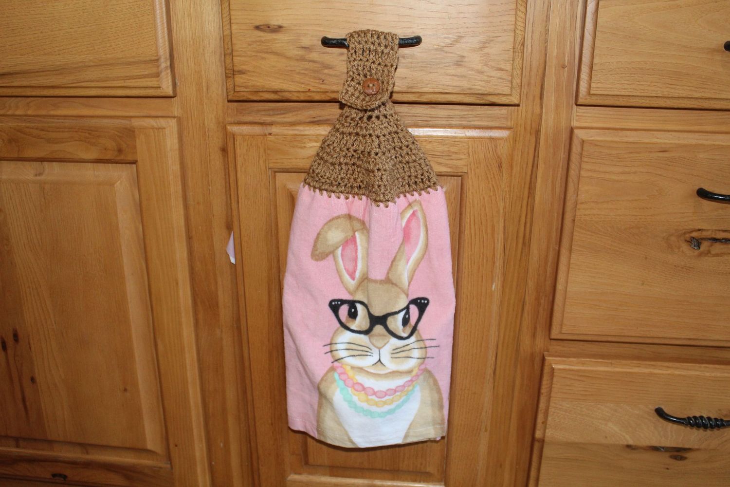 Decorative Easter bunny hanging dish towel with brown crochet top and cute bunny with glasses design.
