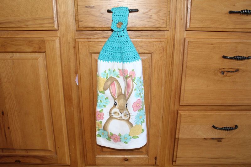 Cute Easter bunny hanging towel with pastel flowers and crochet top holder.