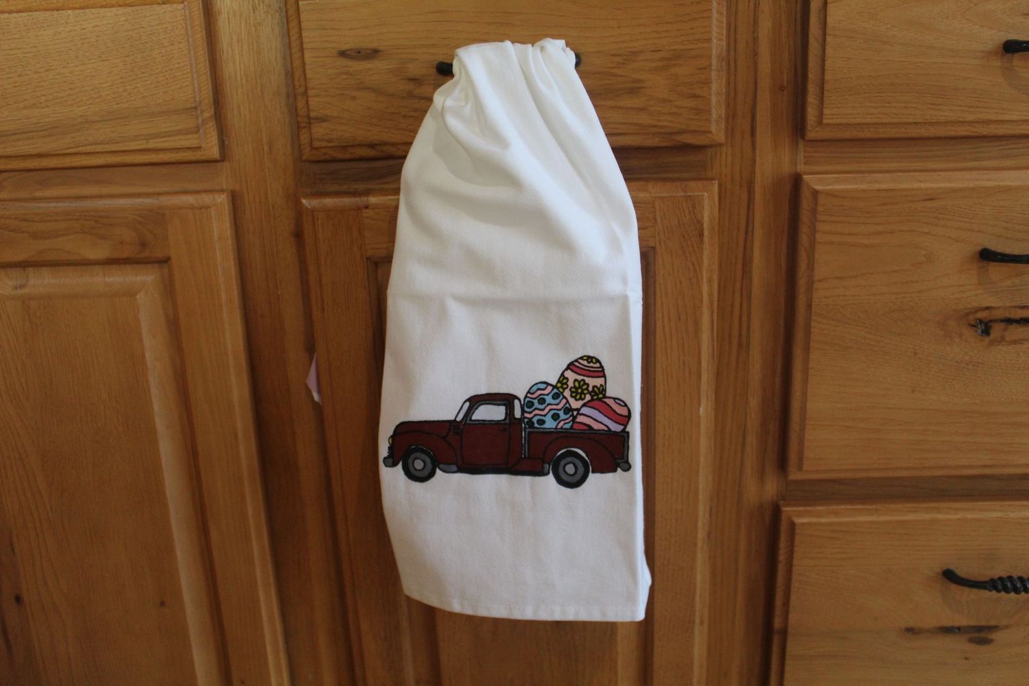 Farmhouse Easter truck kitchen towel with hand painted red pickup and eggs.