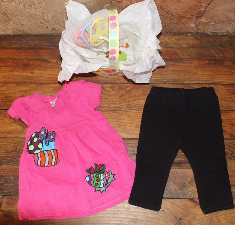 Hand-painted pink baby dress with Easter egg design paired with black leggings and small gift basket set