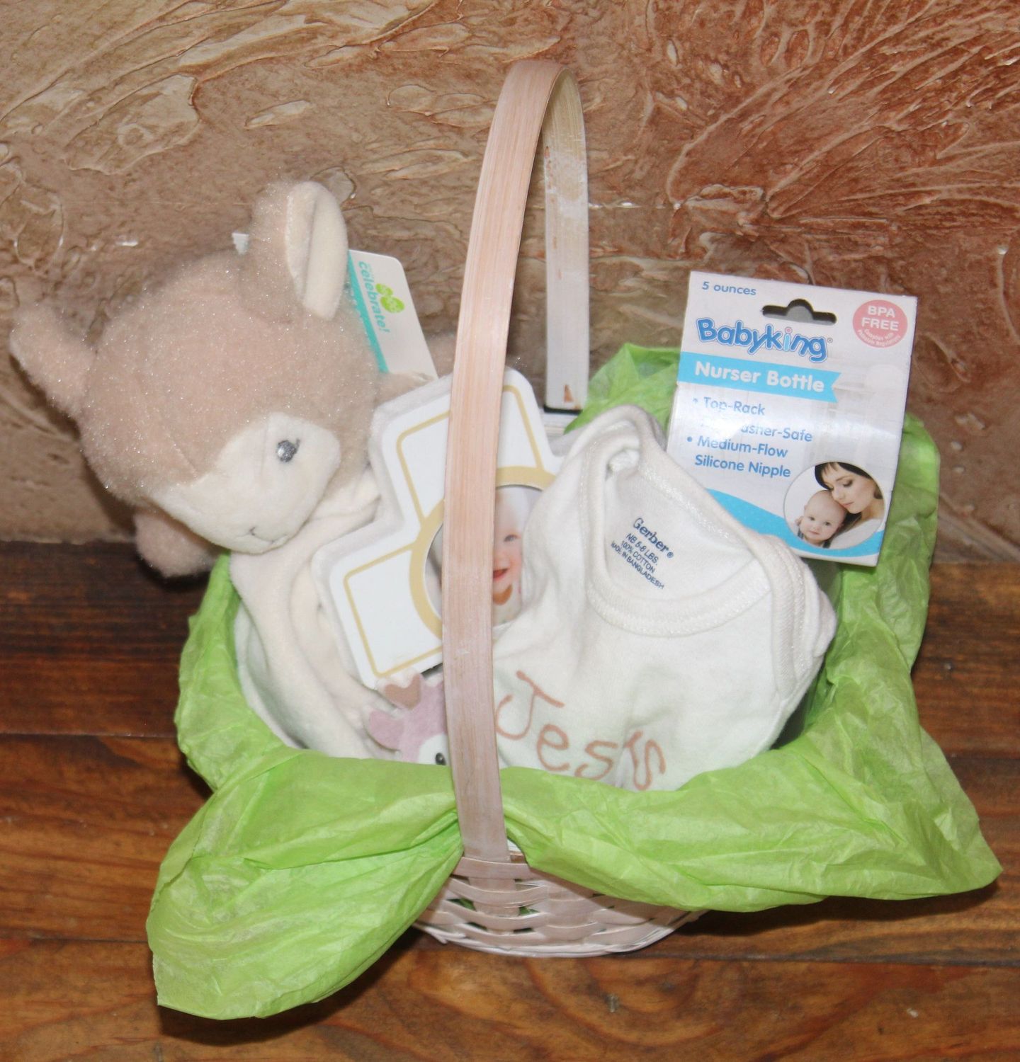 Faith-based baby gift basket with Jesus Loves Me outfit, plush lamb, and Easter keepsake blanket