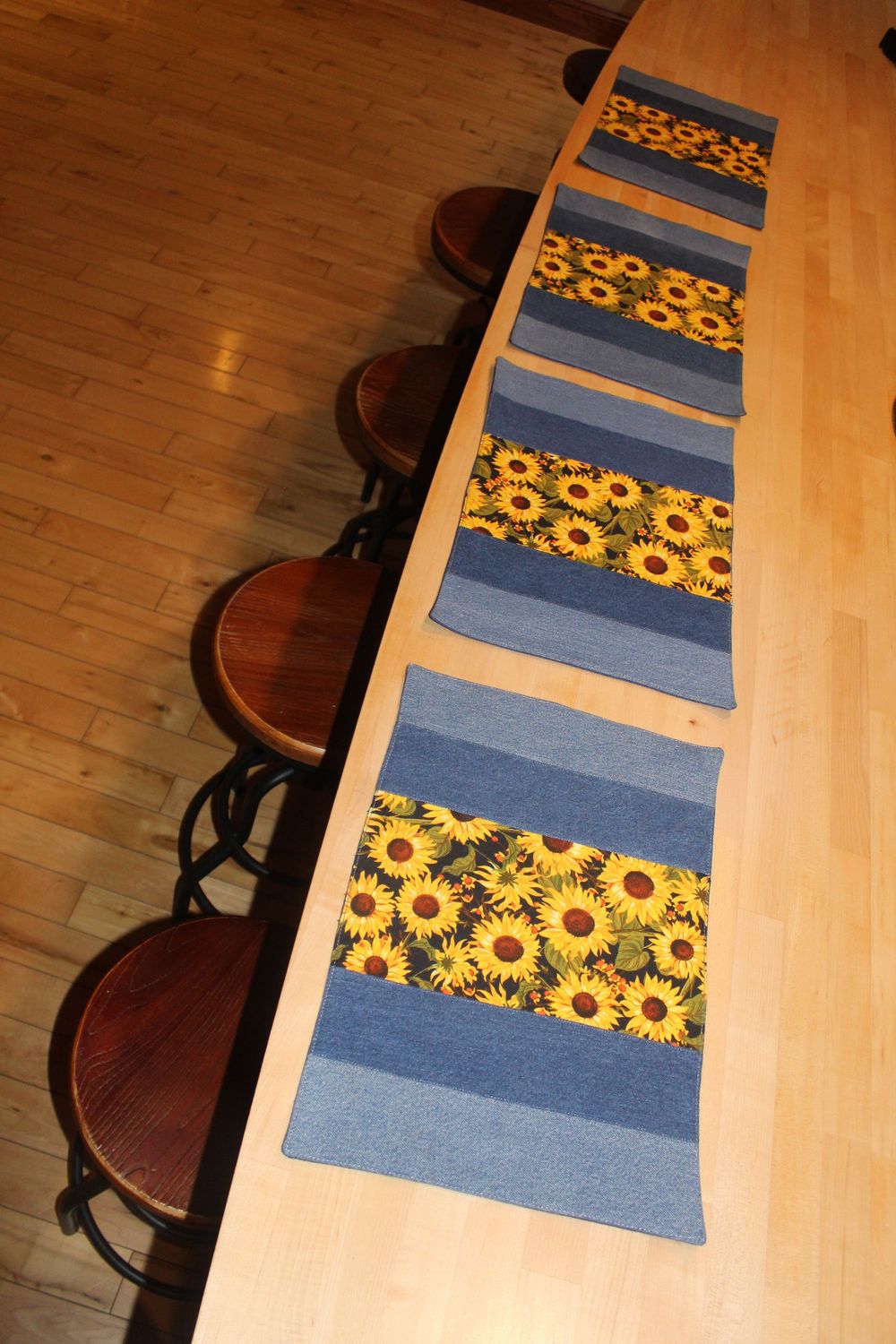 Handmade sunflower placemats set of 4 with denim panels displayed on wooden kitchen island